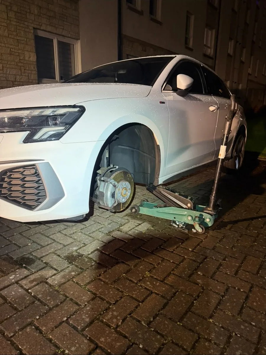 Mobile tyre fitting carried out at night on a driveway