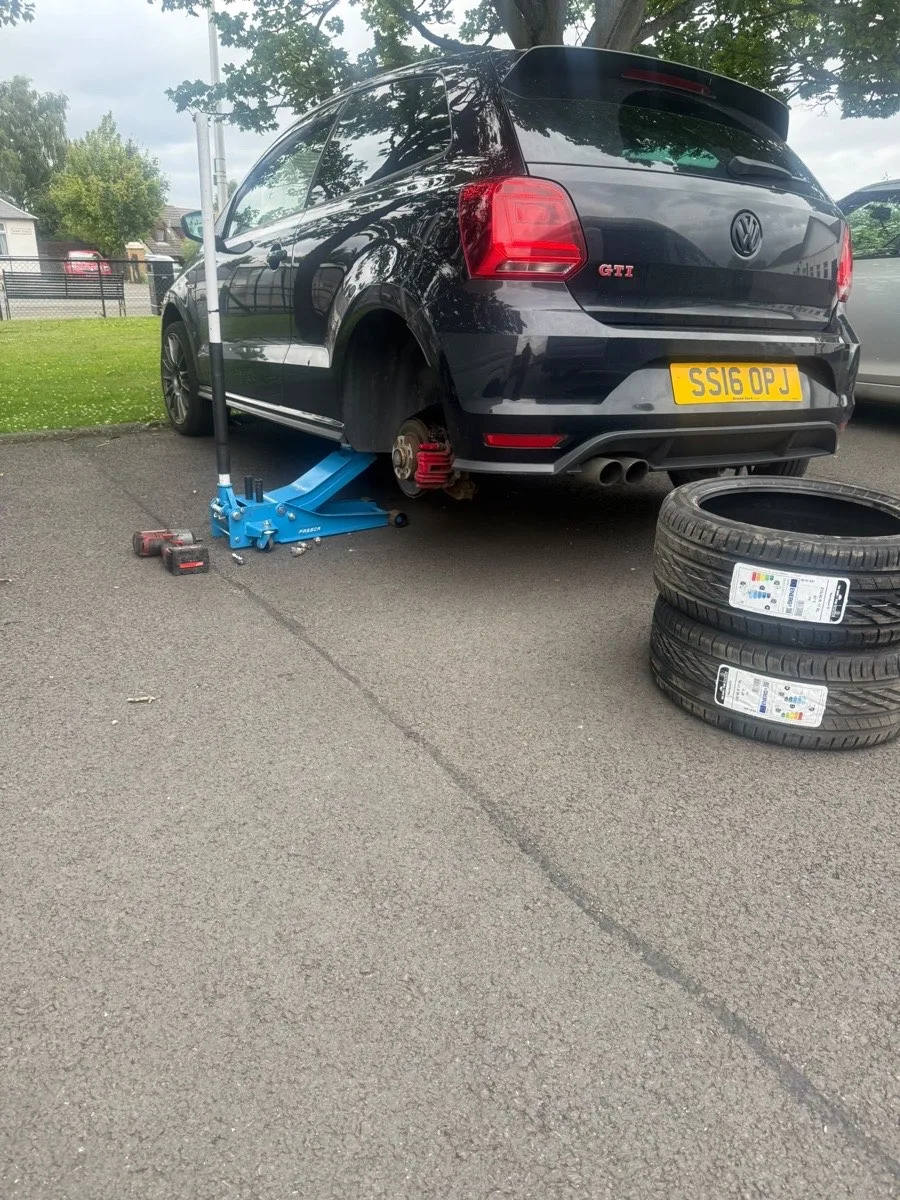 A new tyre ready beside a vehicle