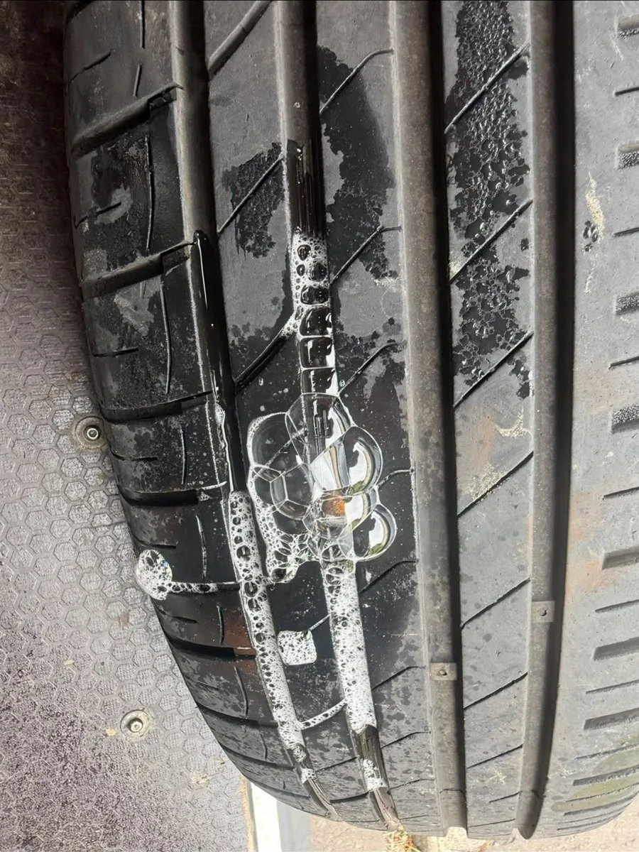 A close-up of a tyre being leak-tested for a puncture