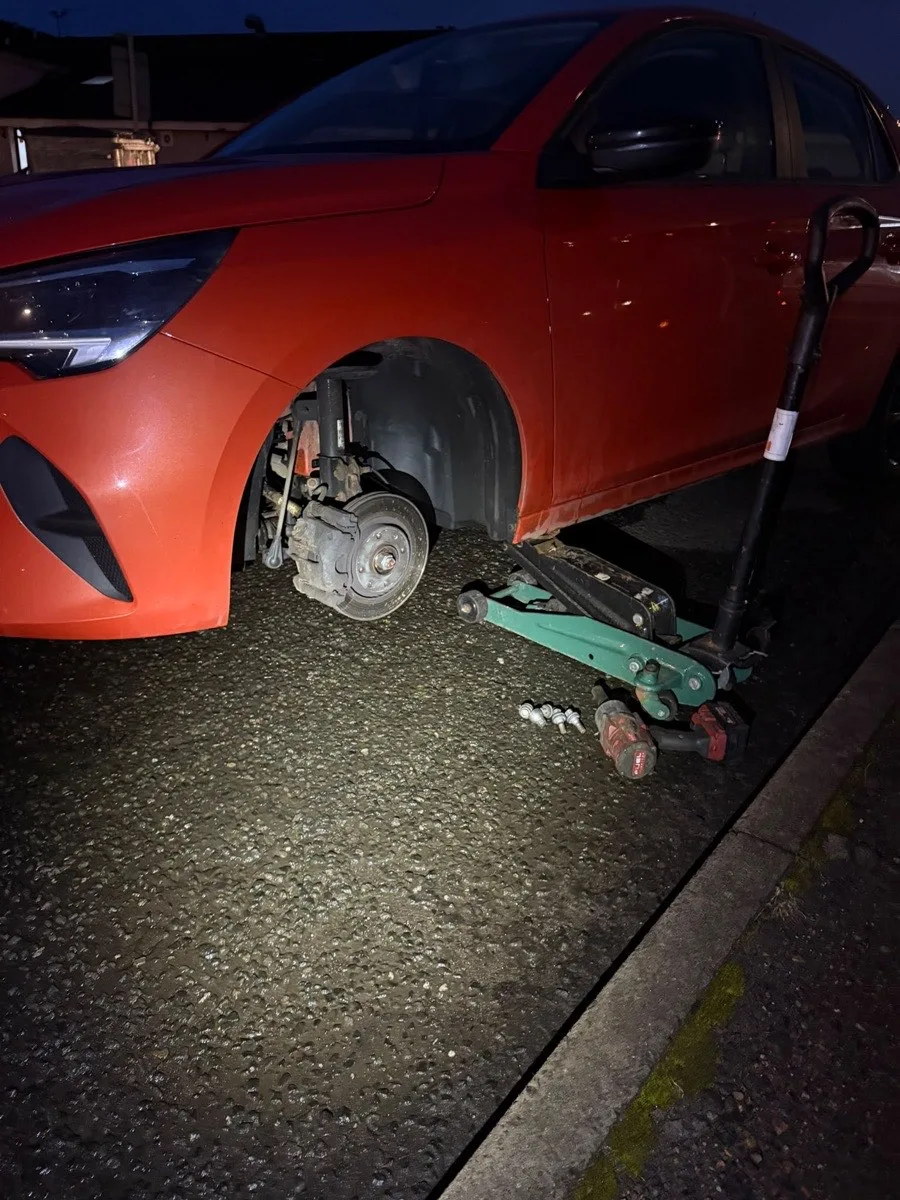 A vehicle raised while a wheel is removed